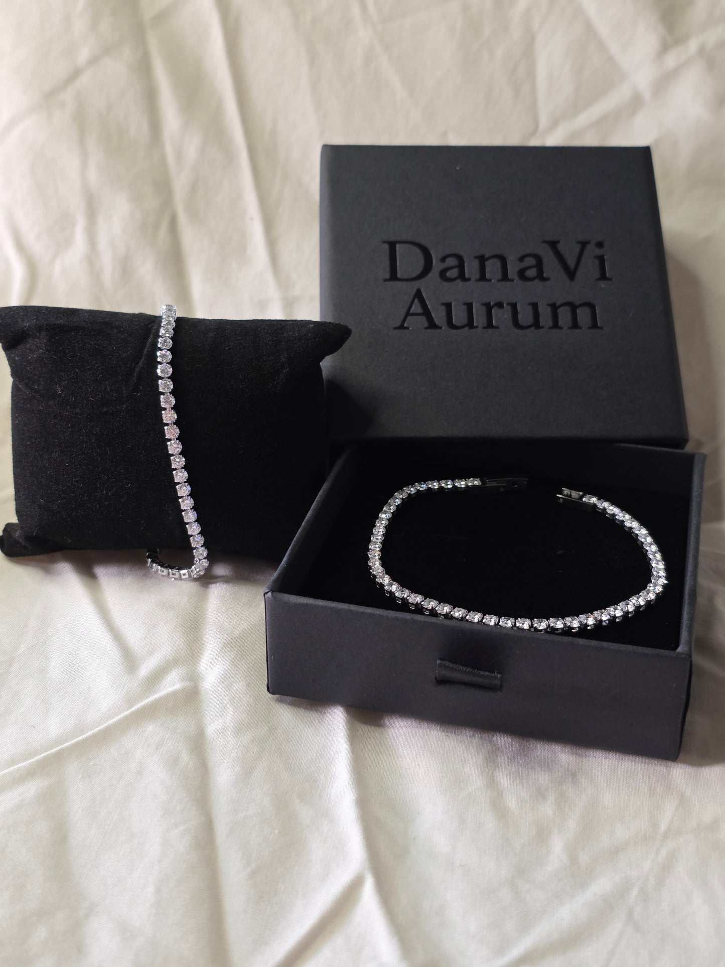 DanaVi Aurum bracelet in an open black box on a white surface