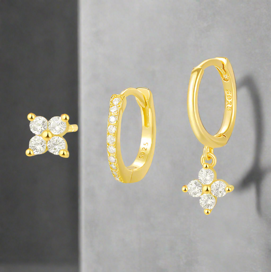 Gold hoop earrings with floral designs on a white background