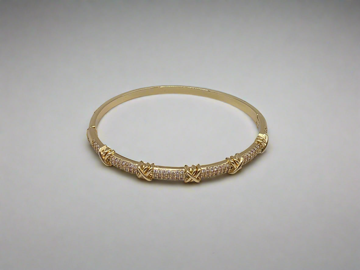 Gold bracelet with intricate design on a light gray background Danavi Aurum