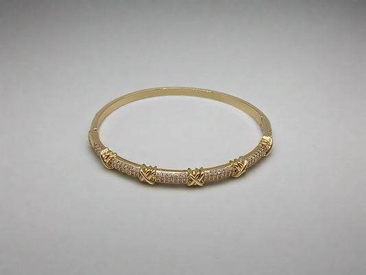 Gold bracelet with intricate design on a light gray background Danavi Aurum