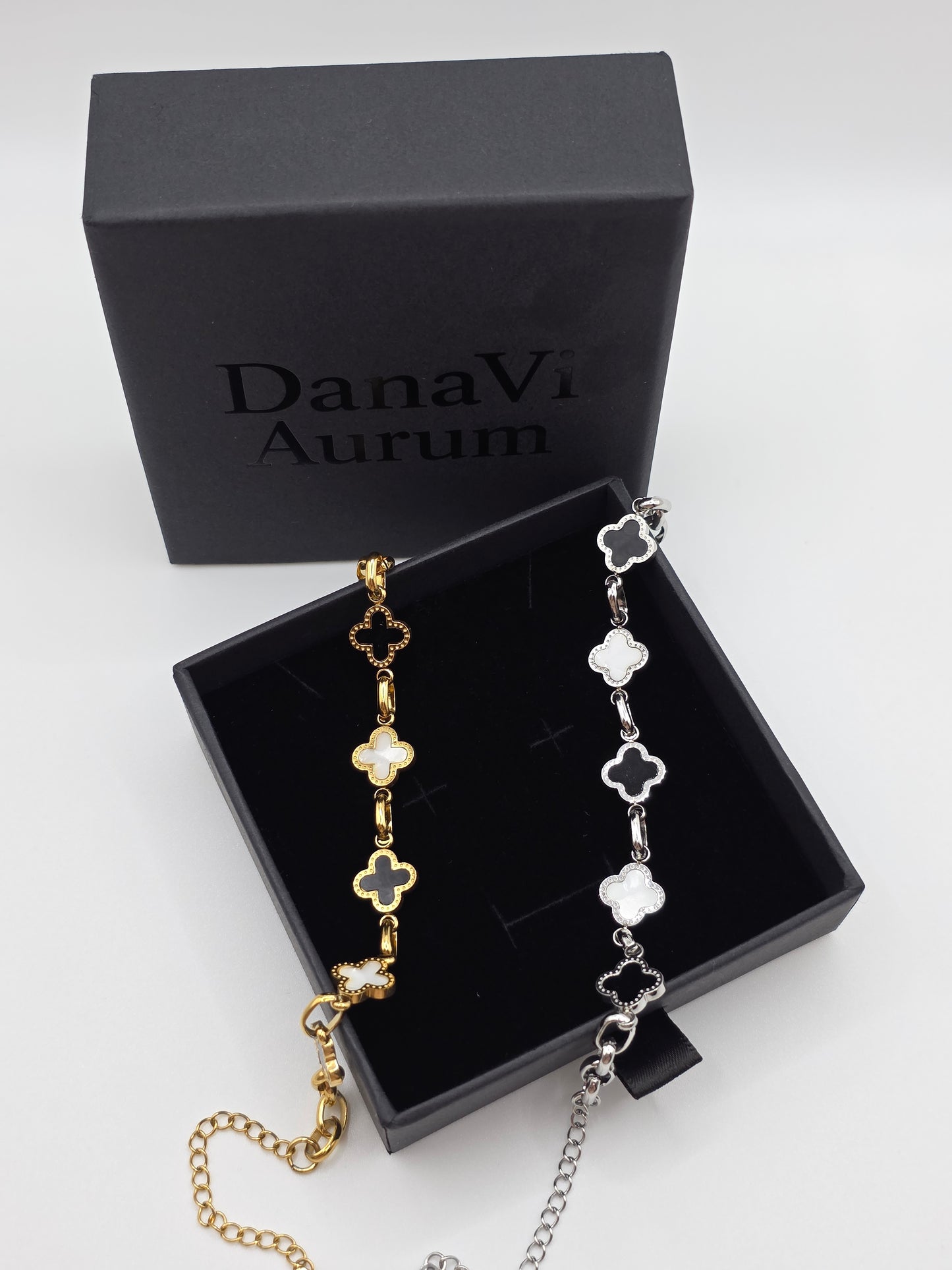 Gold and silver bracelet set in a DanaVi Aurum box on a light gray background