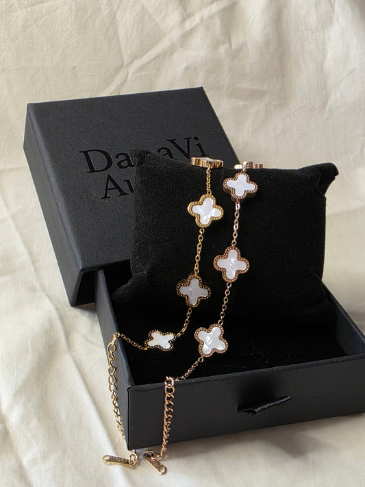 Necklace with floral pendants in a Darnavi Aurum box on a light fabric background