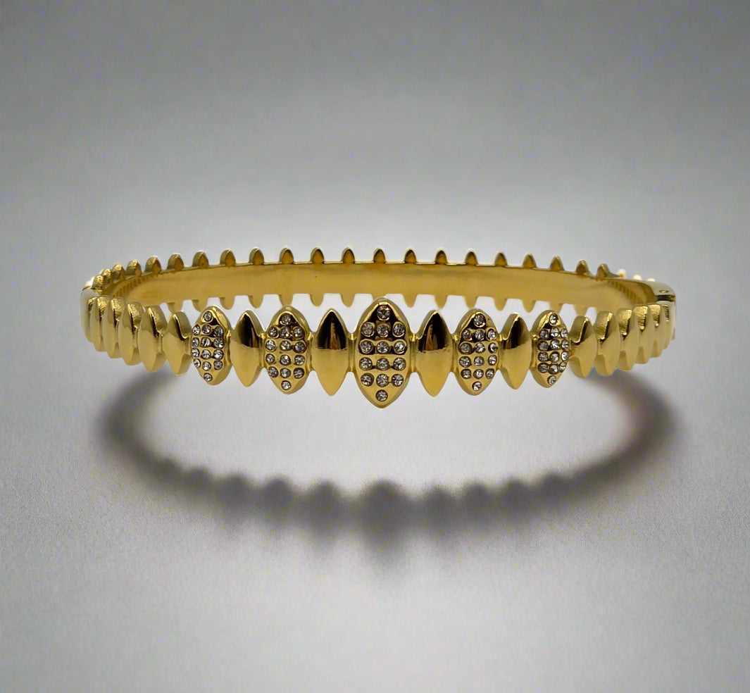 Danavi Aurum Gold bracelet with diamond accents on a light gray background
