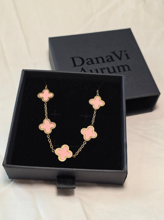 Pink flower-shaped bracelet in a black box with 'DanaVi Aurum' branding.