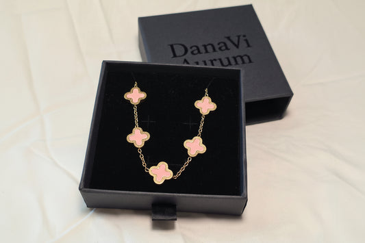 Pink flower-shaped bracelet in a black box with 'DanaVi Aurum' branding.