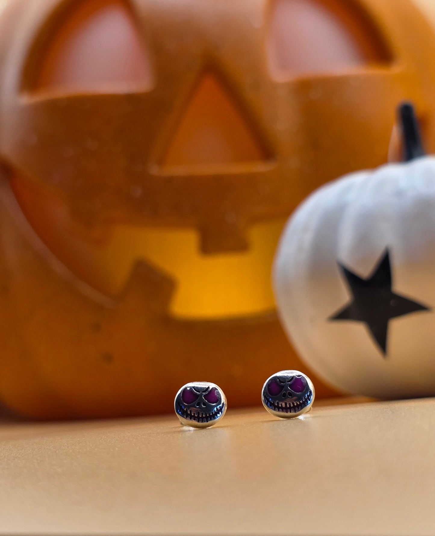 Halloween-themed earrings with a pumpkin and ghost in the background Danavi Aurum