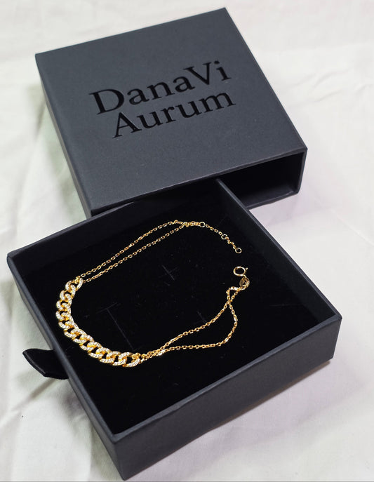 Gold necklace in a black 'Danavi Aurum' box on a light background
