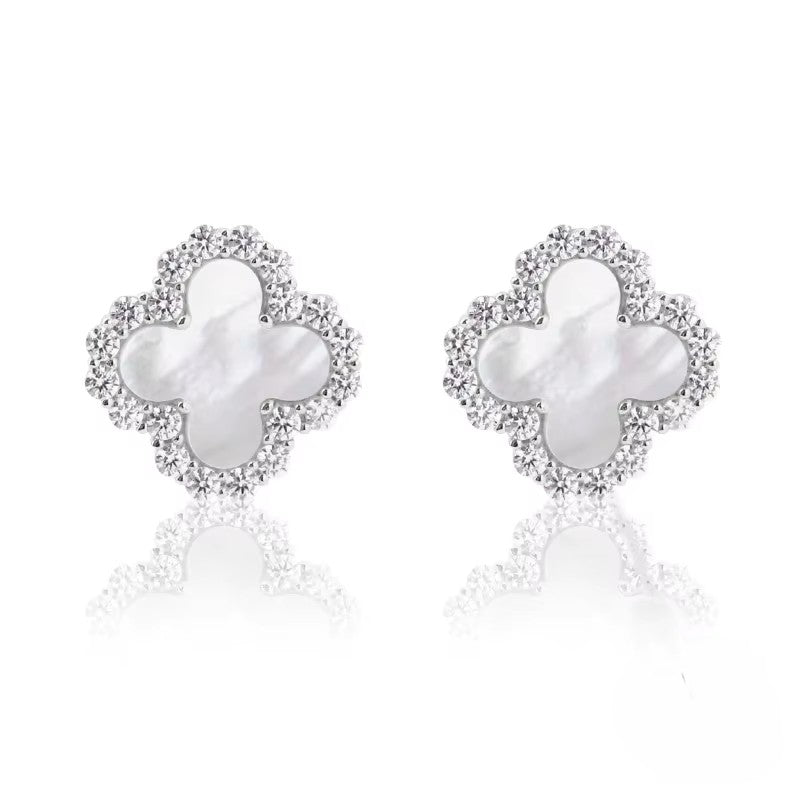 Pair of butterfly-shaped earrings with pearl centers on a white background danavi aurum
