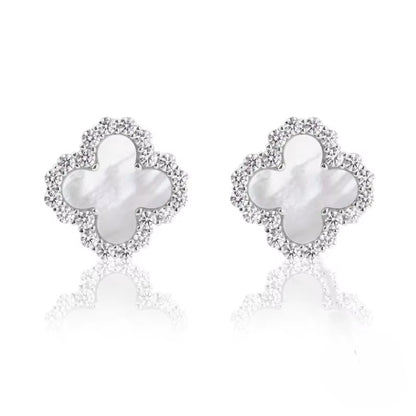 Pair of butterfly-shaped earrings with pearl centers on a white background danavi aurum
