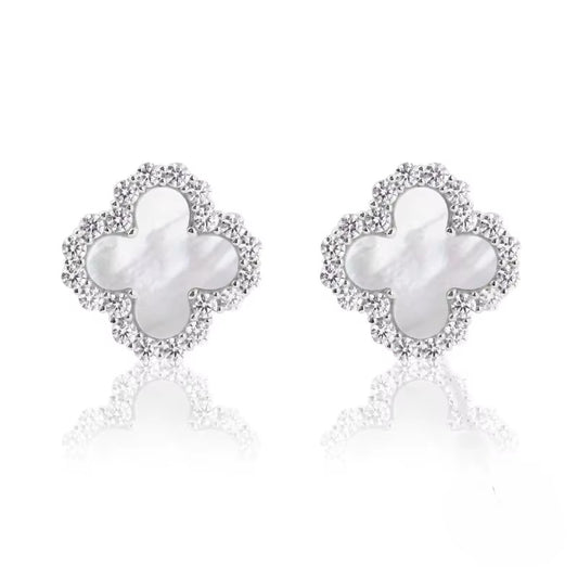 Pair of butterfly-shaped earrings with pearl centers on a white background danavi aurum