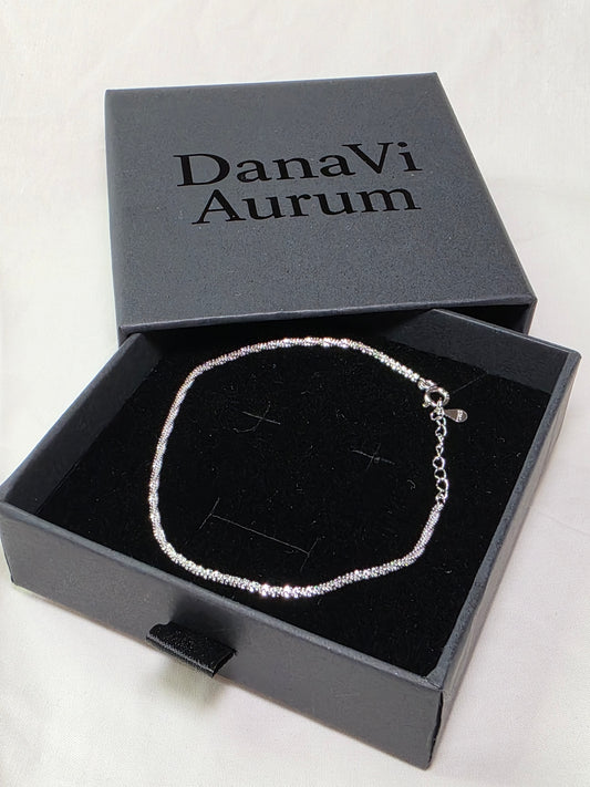 Silver necklace in an open DanaVi Aurum box on a white background