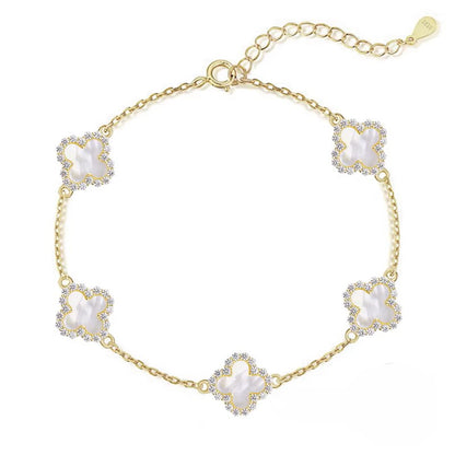 Gold bracelet with floral designs on a white background