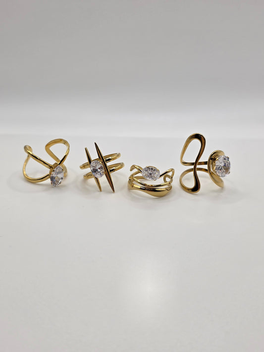 Set of gold earrings with gemstones on a light gray background Danavi Aurum