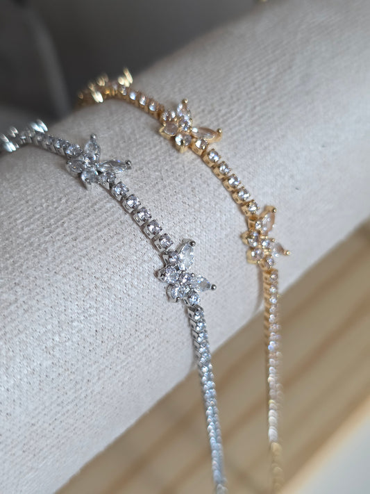 Silver bracelet with buterfly designs on a white cushion UK based