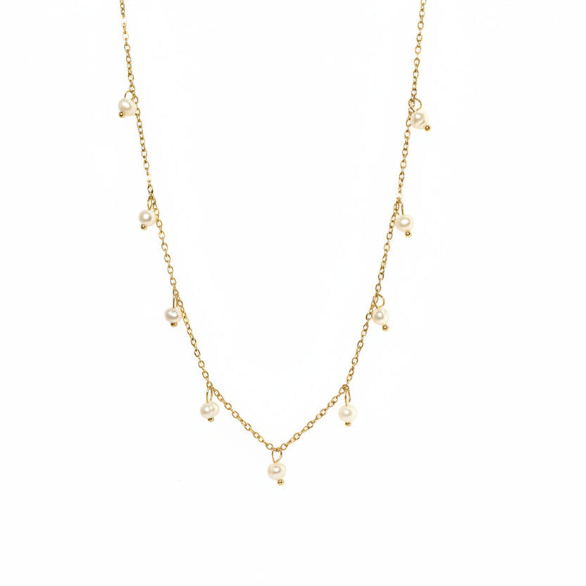 Gold chain necklace with pearls on a light gray background danavi aurum