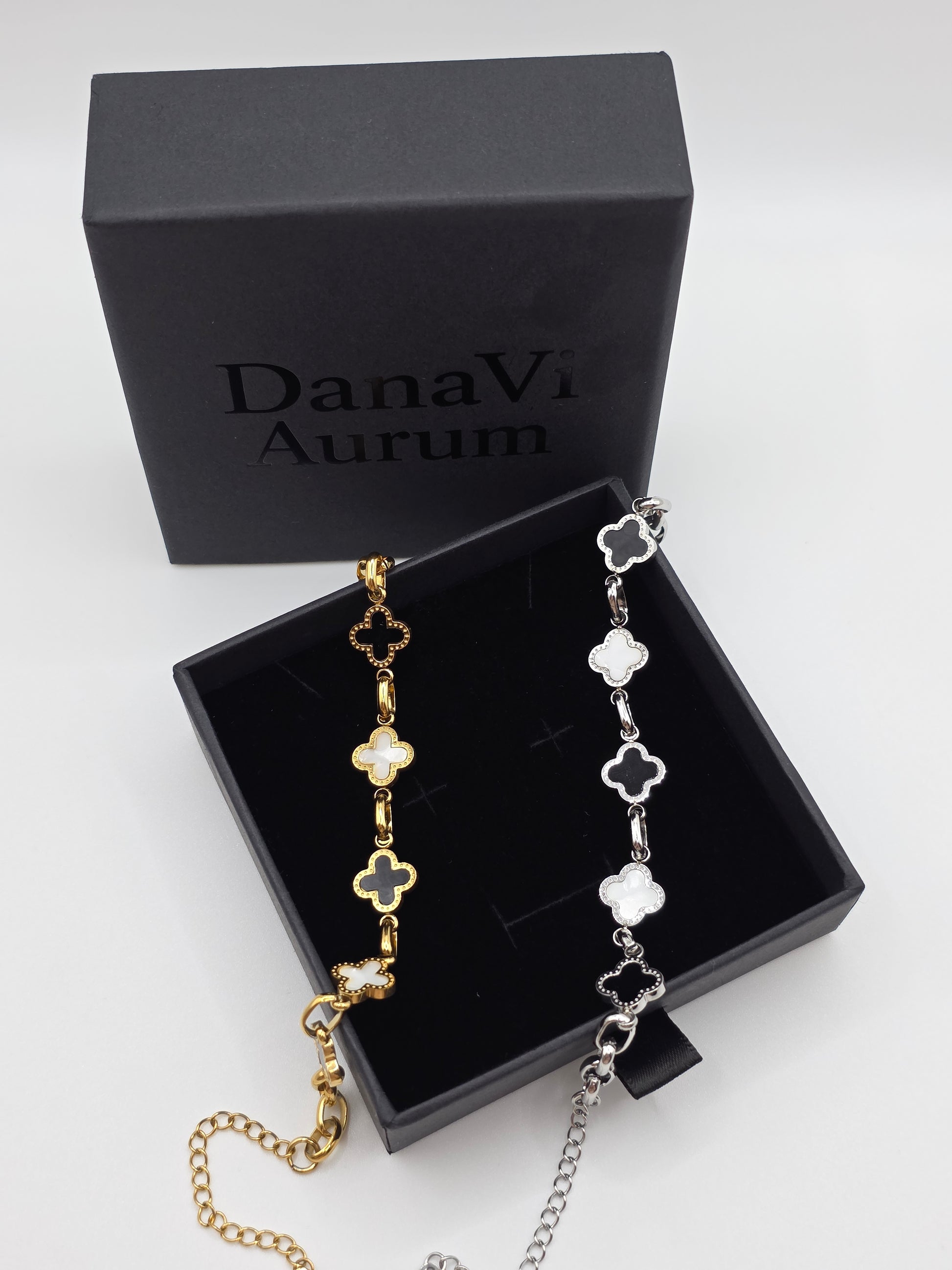 Gold and silver bracelet set in a DanaVi Aurum box on a light gray background