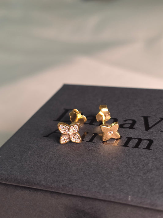 Gold earrings with four leaf clover design on a branded danavi aurum boxd