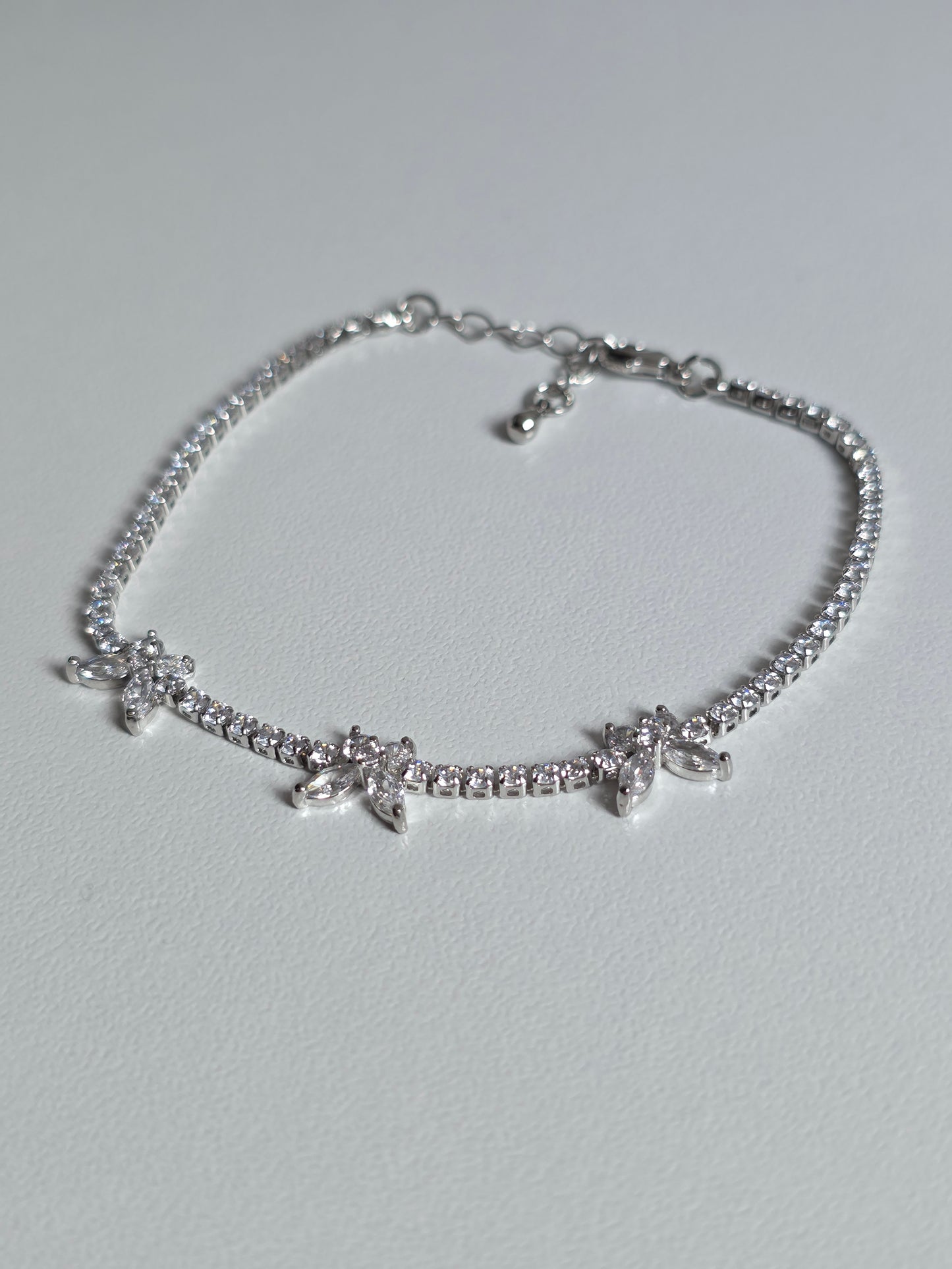 Gold-plated Butterfly Tennis Bracelet with sparkly zirconia stones – close-up image on cushion – DanaVi Aurum Jewellery UK