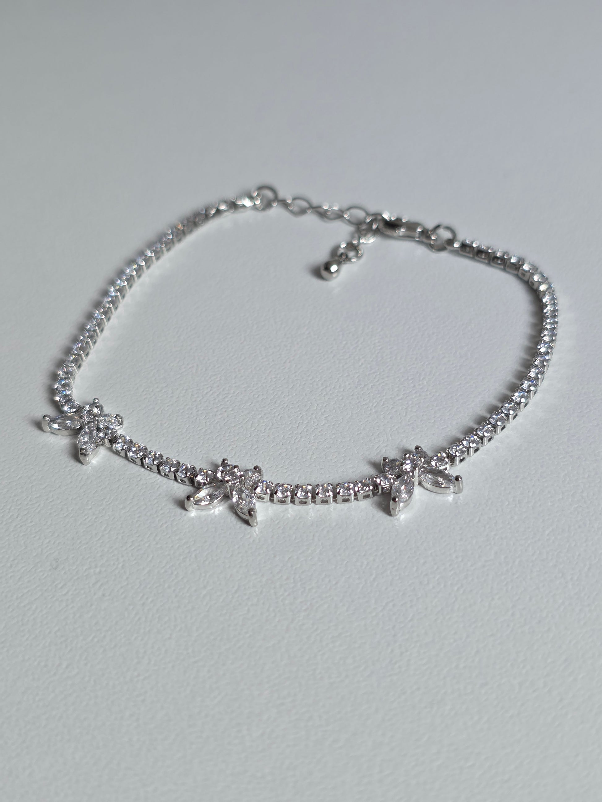 Gold-plated Butterfly Tennis Bracelet with sparkly zirconia stones – close-up image on cushion – DanaVi Aurum Jewellery UK