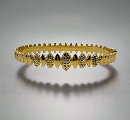 Danavi Aurum Gold bracelet with diamond accents on a light gray background