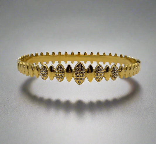 Danavi Aurum Gold bracelet with diamond accents on a light gray background