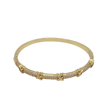 Gold bracelet with diamond accents on a light gray background danavi aurum