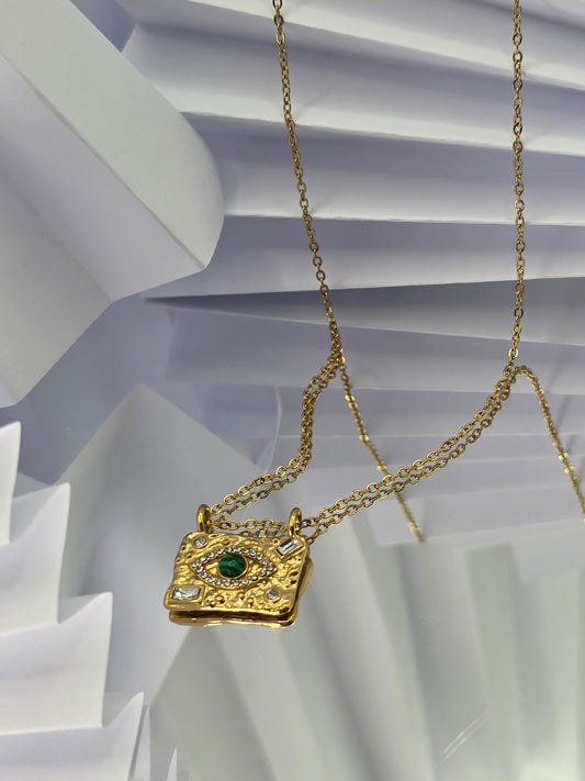 Gold necklace with a pendant on a white background danavi aurum