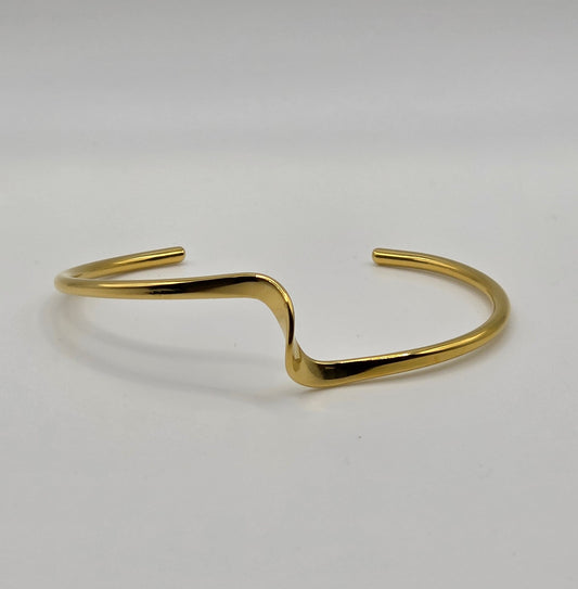Gold metal hook on a light gray background Danavi Aurum