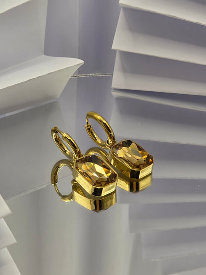 Gold earring on a white background danavi aurum