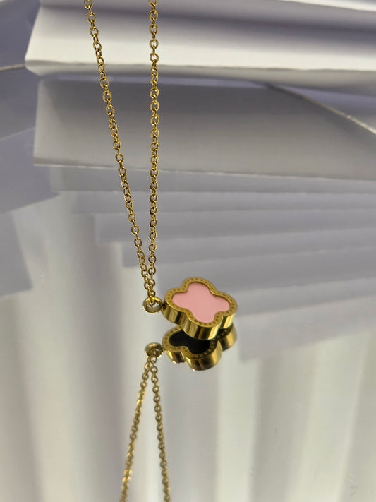Gold necklace with a pink clover-shaped pendant on a white background danavi aurum