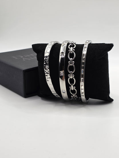 Set of silver bracelets on a black cushion with a white background danavi Aurum