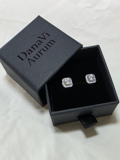 Diamond earrings in a black jewelry box with 'Danavi Aurum' branding on a light gray background