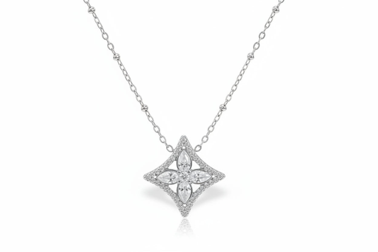 silver necklace with a diamond pendant on a white background